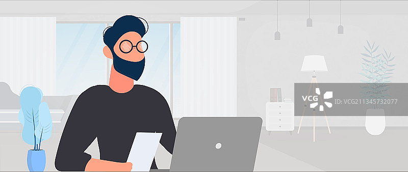 戴眼镜的男人坐在办公室的桌子旁图片素材