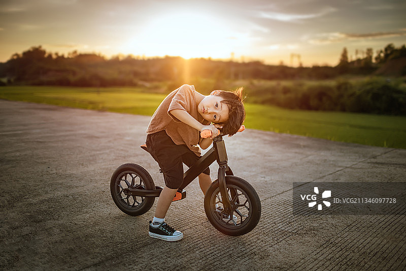 夏天的傍晚骑平衡车的小男孩图片素材
