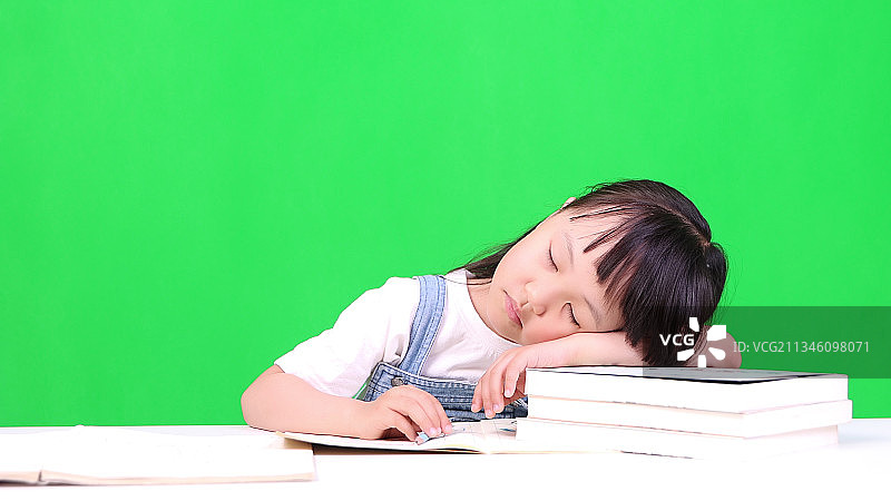 写作业趴在书上睡着了的孩子图片素材