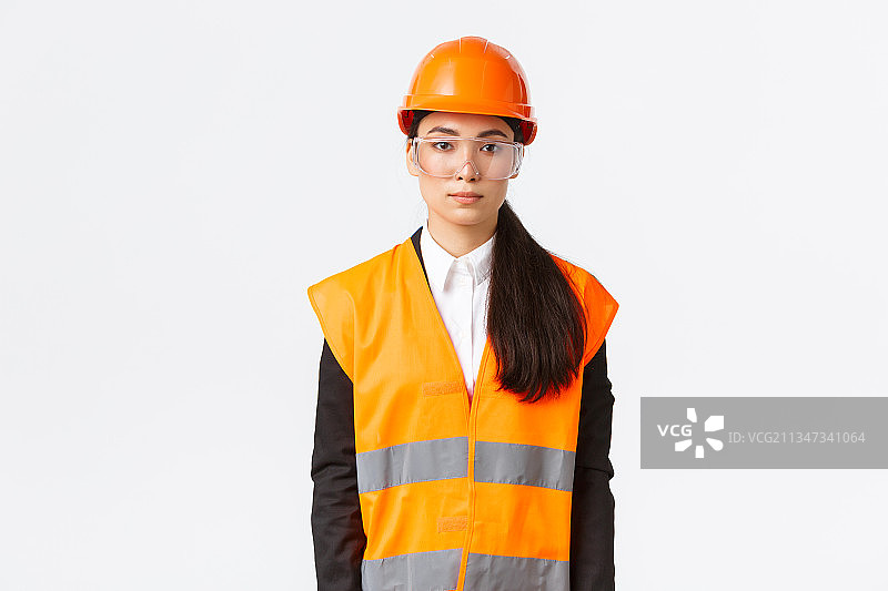 戴着安全帽站在白色背景前的女模特肖像图片素材