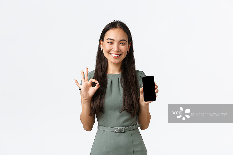 站在白色背景前做手势的微笑女商人肖像图片素材