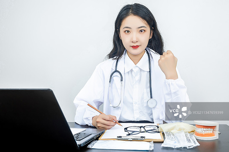 亚洲青年女性医生在电脑前专心工作图片素材