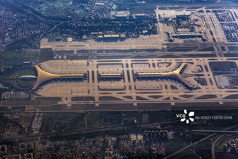 黄昏时分高空飞越首都国际机场俯瞰T3航站楼和跑道图片素材