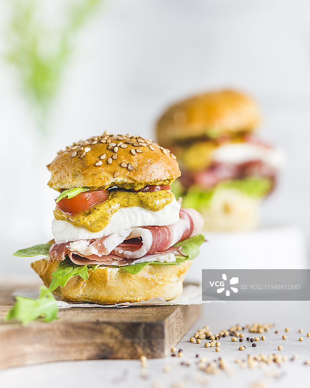 配芝麻菜、帕尔马火腿、樱桃番茄和农场芥末的迷你汉堡图片素材