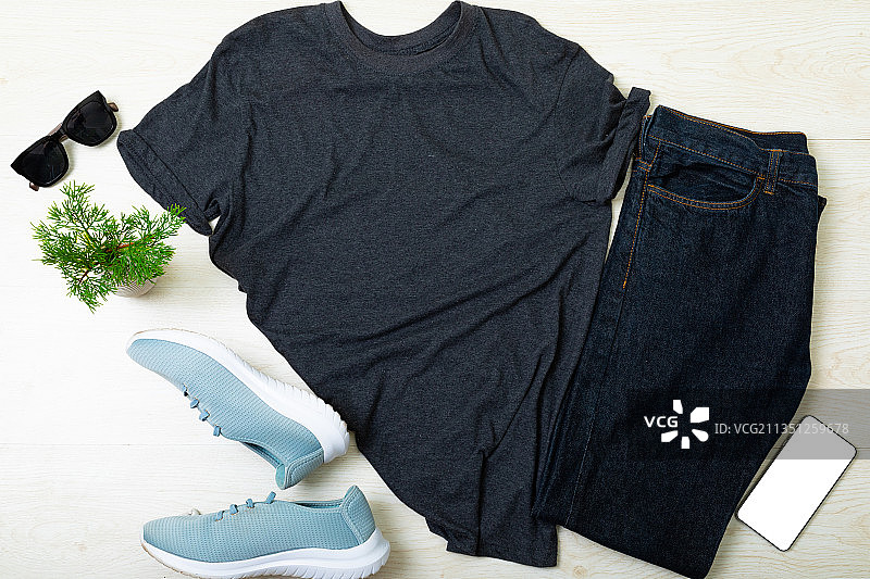 衣服、鞋子、太阳镜、智能手机和树枝在木质背景上的组合图片素材