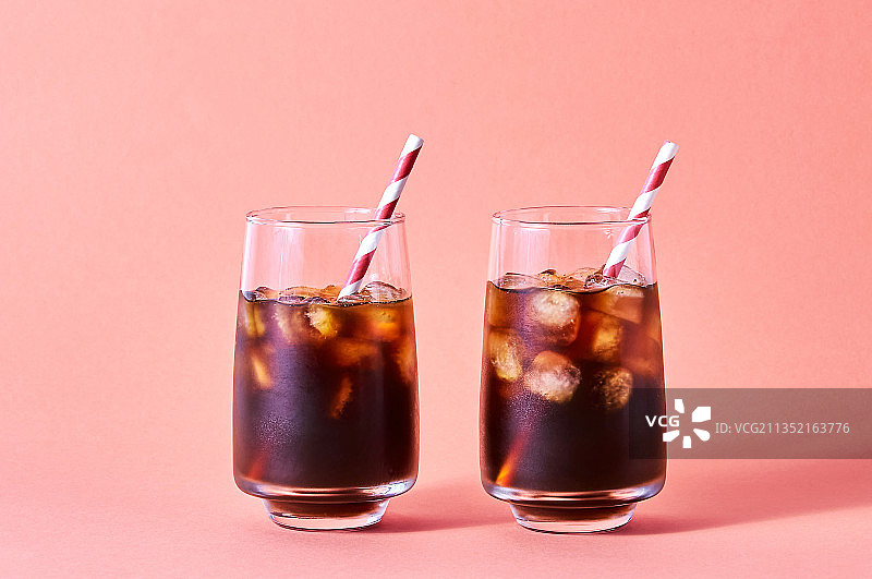 粉色背景下的玻璃杯饮品特写图片素材