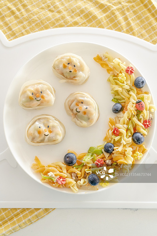 儿童餐蔬菜蒸饺和彩色面条图片素材