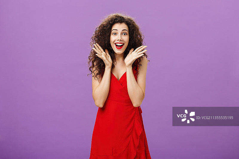 站在紫色背景前的微笑女人图片素材