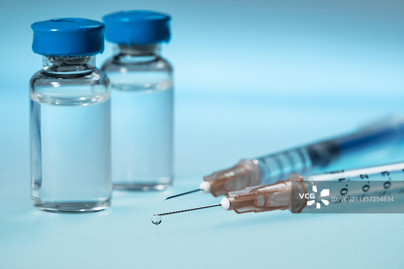 蓝色玻璃药瓶与注射器特写图片素材