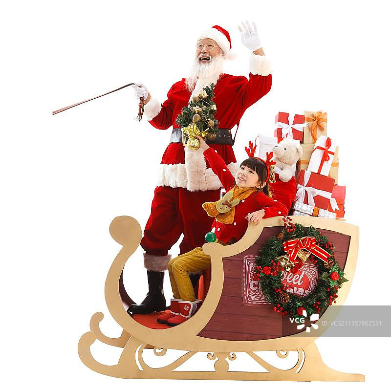 圣诞老人和小女孩在雪橇上招手图片素材