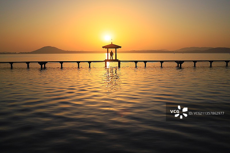 夕阳下湖天桥的剪影图片素材