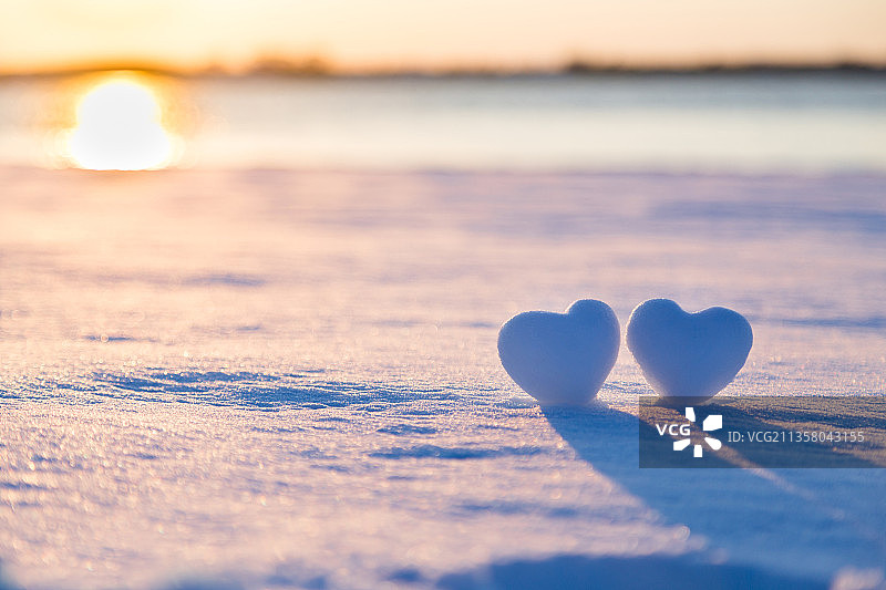 夕阳下的两个爱心雪球图片素材