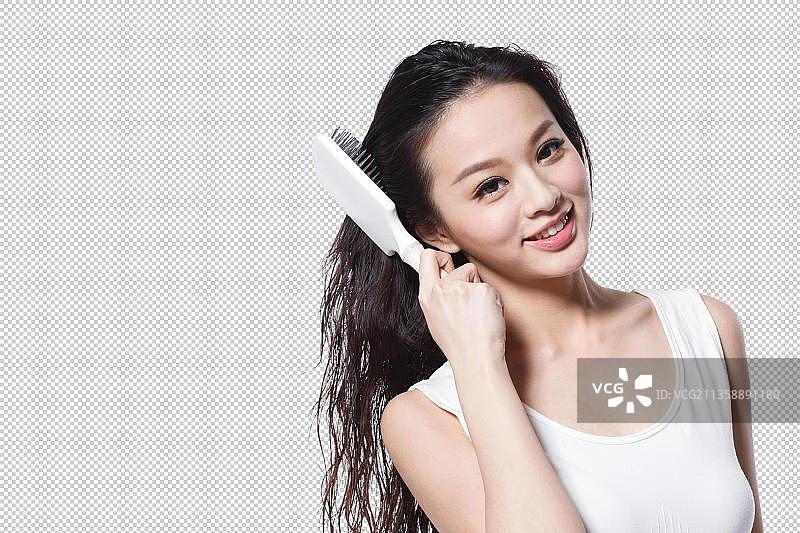 东方美女拿着梳子正在梳头图片素材