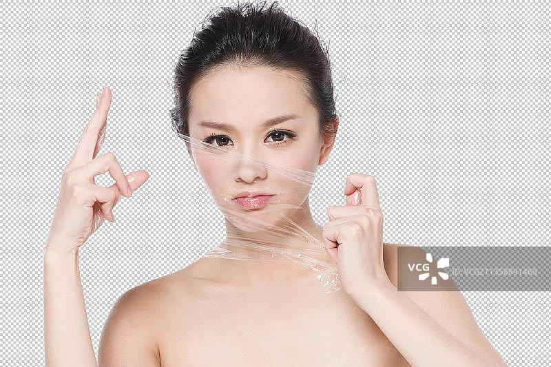 东方美女在用力撕扯保鲜膜图片素材