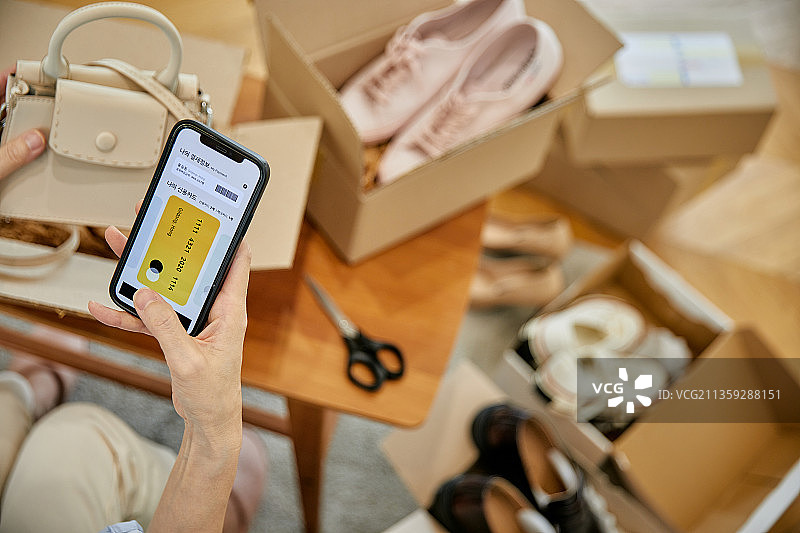 中年妇女使用手机进行海淘购物和移动支付图片素材