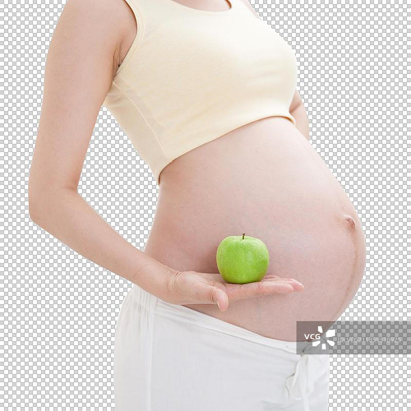 孕妇拿着青苹果图片素材