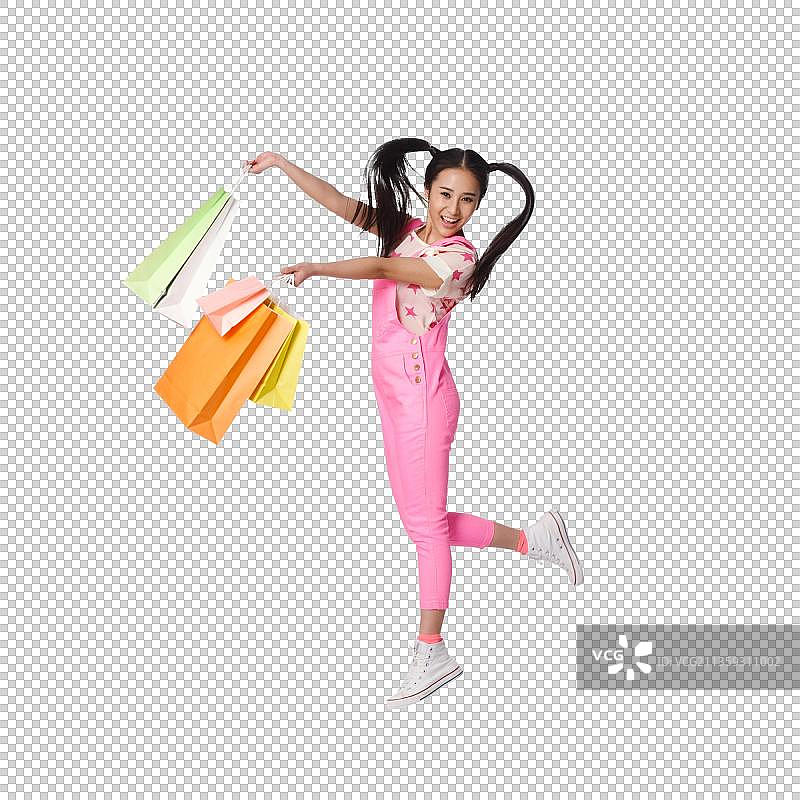 青春活力的年轻女孩手提购物袋图片素材