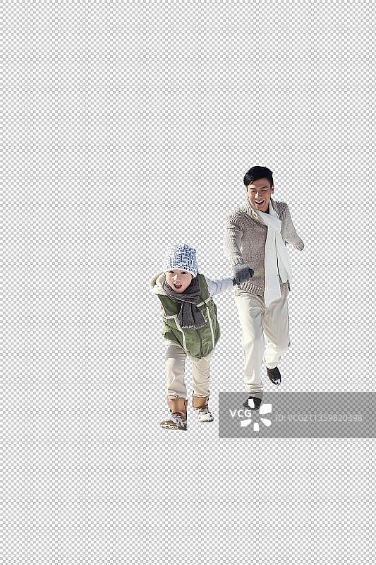 父亲和儿子在雪地上奔跑图片素材