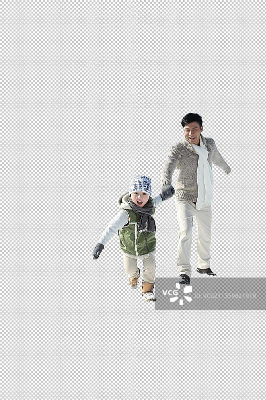 父亲和儿子在雪地上奔跑图片素材
