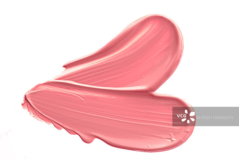 白色背景上涂抹的珊瑚色化妆品图片素材