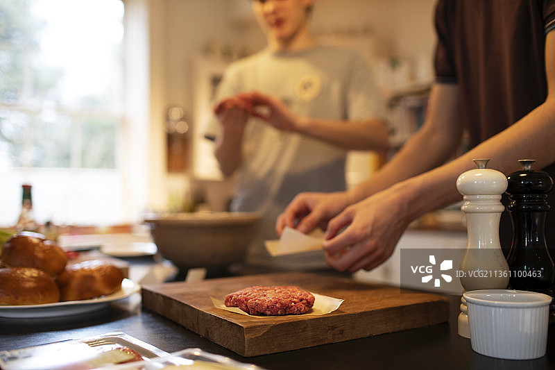 青少年在厨房做汉堡肉饼图片素材