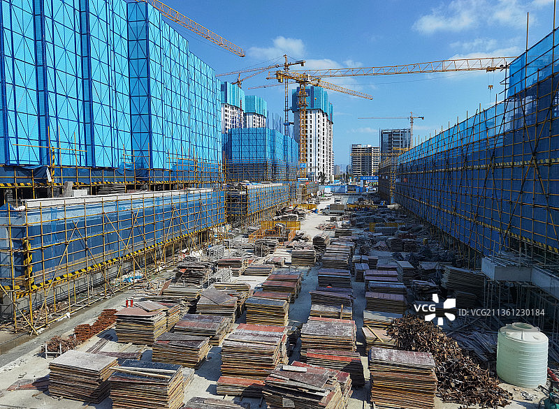 整洁的现代工地富有美感的整齐的蓝色米字格脚手架以及塔吊图片素材