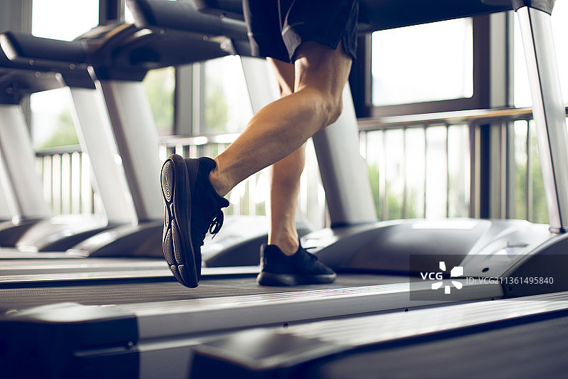 年轻男士在健身房跑步图片素材