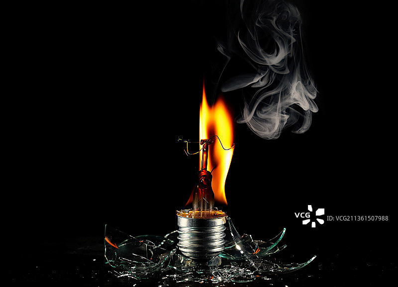 灯泡特写，黑色背景下的火焰效果图片素材