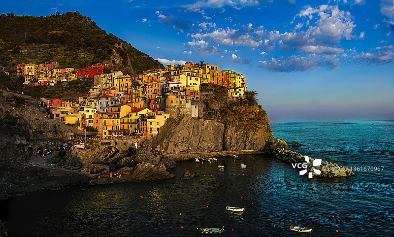 黄金时段的马纳罗拉，意大利拉斯佩齐亚马纳罗拉码头建筑旁的壮丽海景图片素材