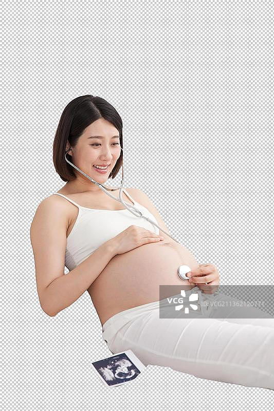 孕妇戴听诊器听胎儿声音图片素材