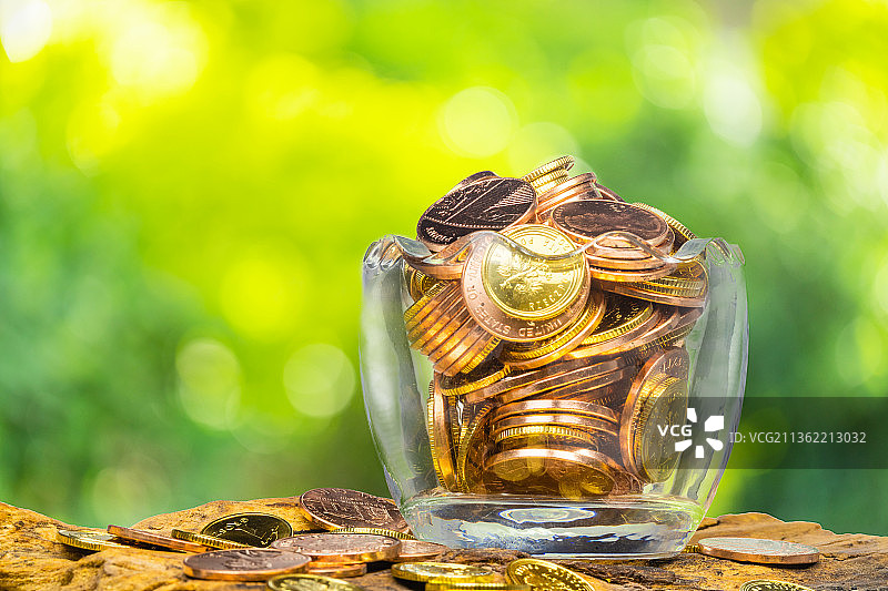 玻璃瓶中放满了金色的硬币图片素材