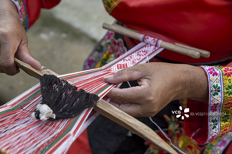 广东韶关畲族人正在编织传统服饰工艺品图片素材