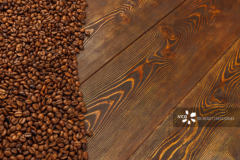 棕色木桌上的烘焙咖啡豆图片素材