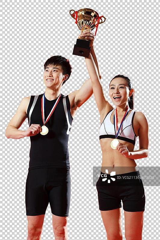 高举奖杯的运动员图片素材