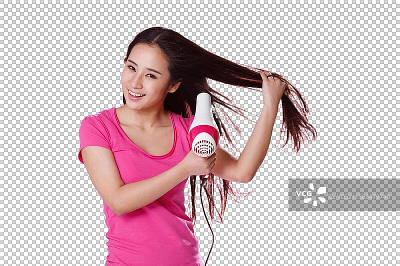 青春活力的年轻女孩吹头发图片素材