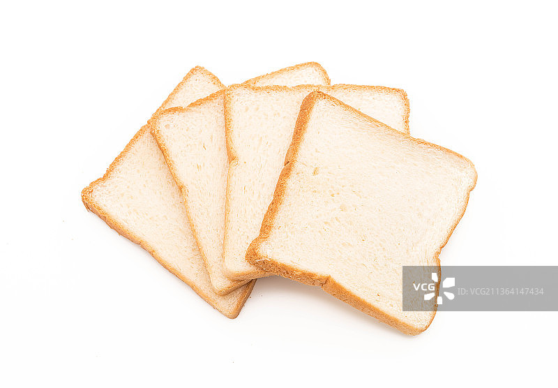 白色背景上的牛奶面包切片，面包切片的特写图片素材