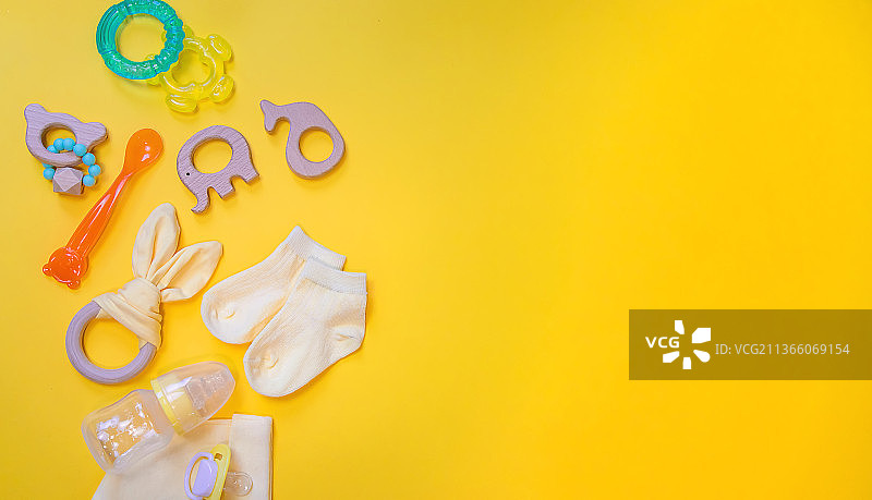 黄色背景上的新生儿用品（选择性焦点）图片素材