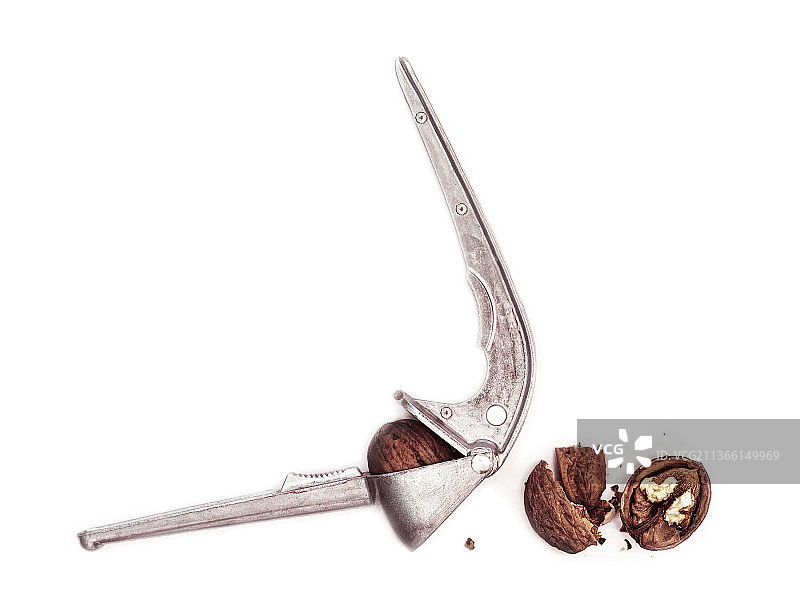蒜 प्रेस 中的核桃，孤立，白色背景上的钥匙特写图片素材