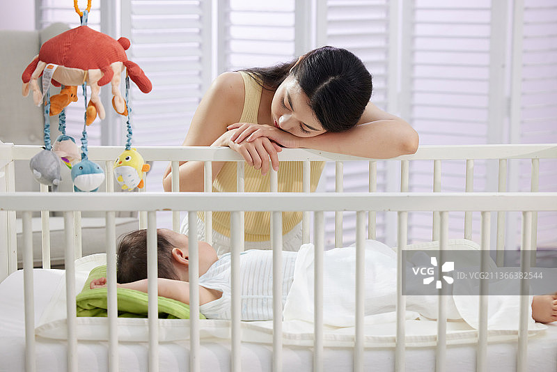 年轻妈妈陪伴宝宝睡觉图片素材
