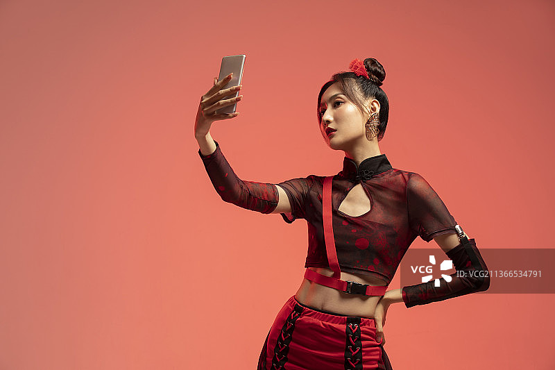 年轻国潮女子拿着手机自拍图片素材