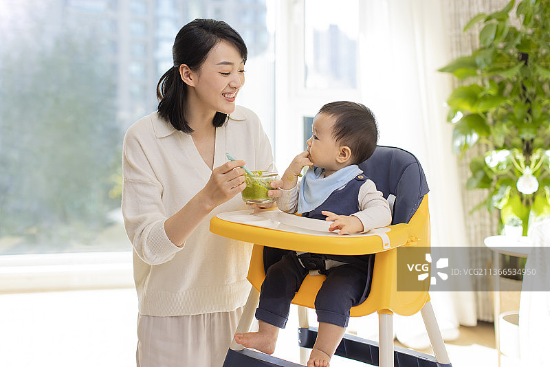 年轻妈妈给宝宝喂食图片素材