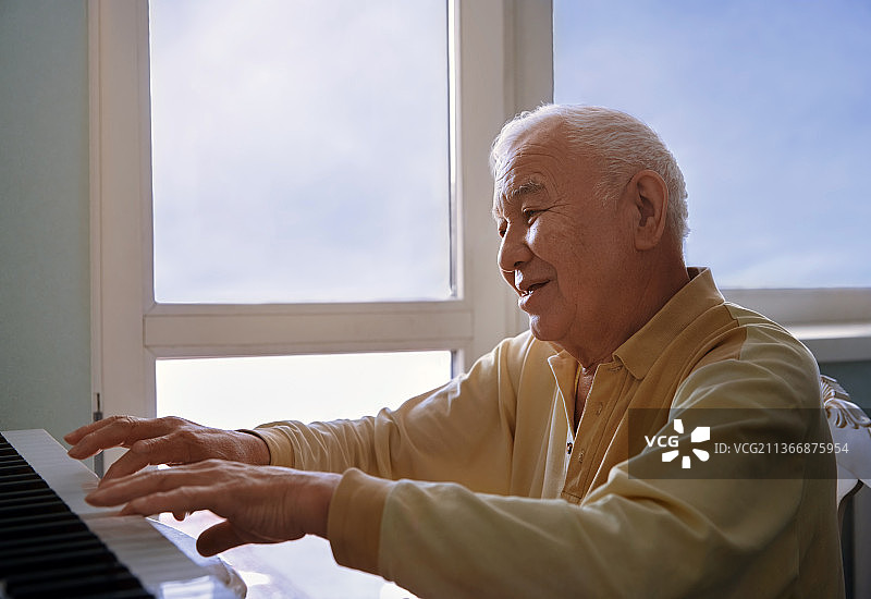 演奏电子钢琴的活力老年男人图片素材