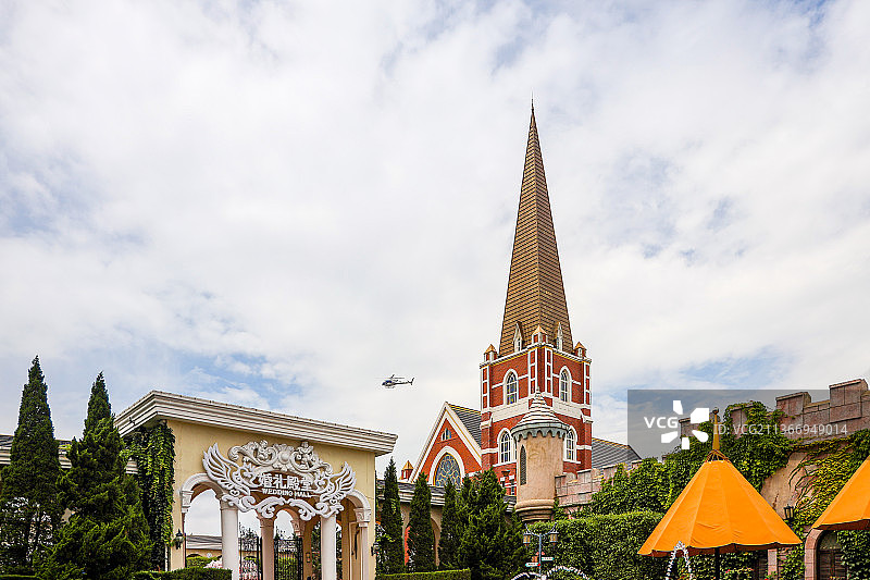 辽宁大连发现王国主题公园红色城堡尖顶塔与婚礼礼堂和直升机图片素材