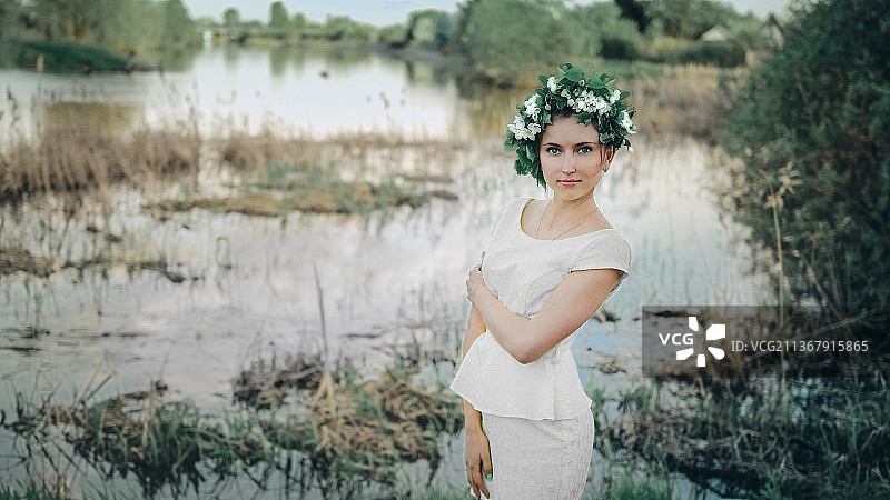 美丽的年轻女子站在植物旁，俄罗斯鄂木斯克图片素材