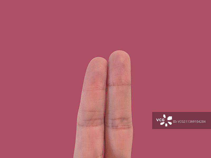 粉红色背景上的两根手指图片素材