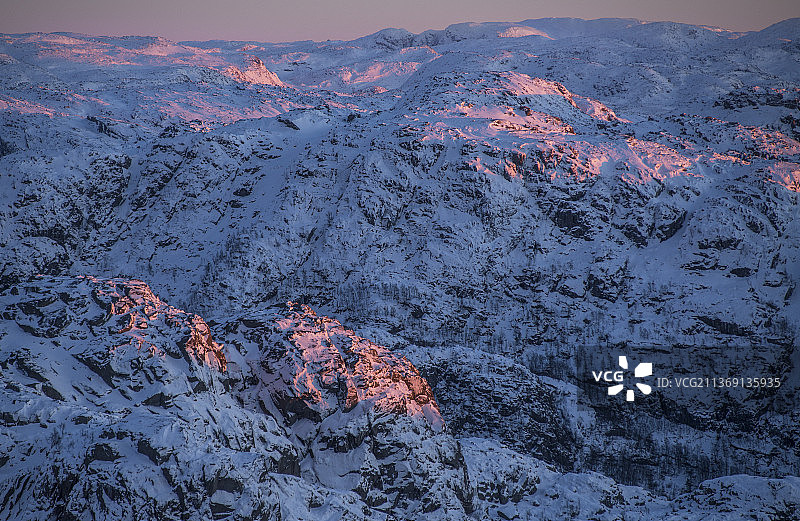 挪威罗加兰郡雪山的最后一缕阳光航拍图片素材