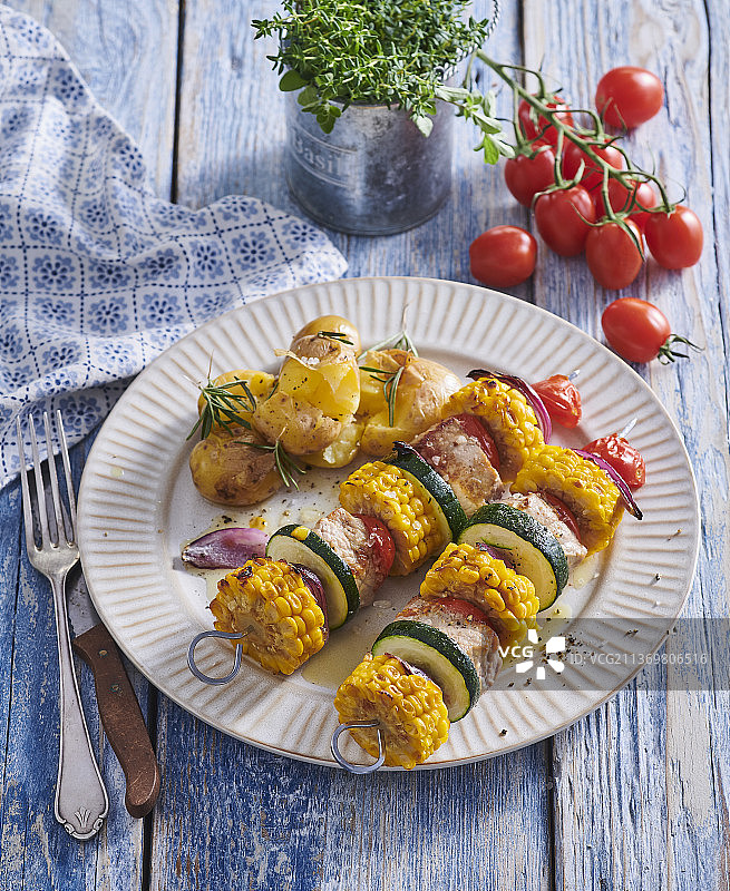 猪肉烤肉配甜玉米和西葫芦图片素材
