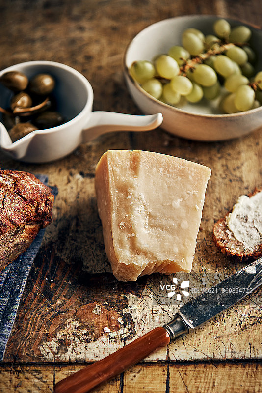 格拉纳帕达诺奶酪、葡萄、面包和刺山柑苹果静物摄影图片素材