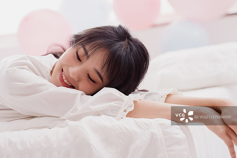 年轻女人在床上躺着图片素材