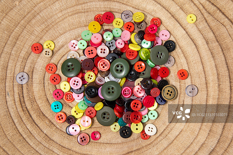 木质背景上的一把彩色纽扣的微距照片图片素材
